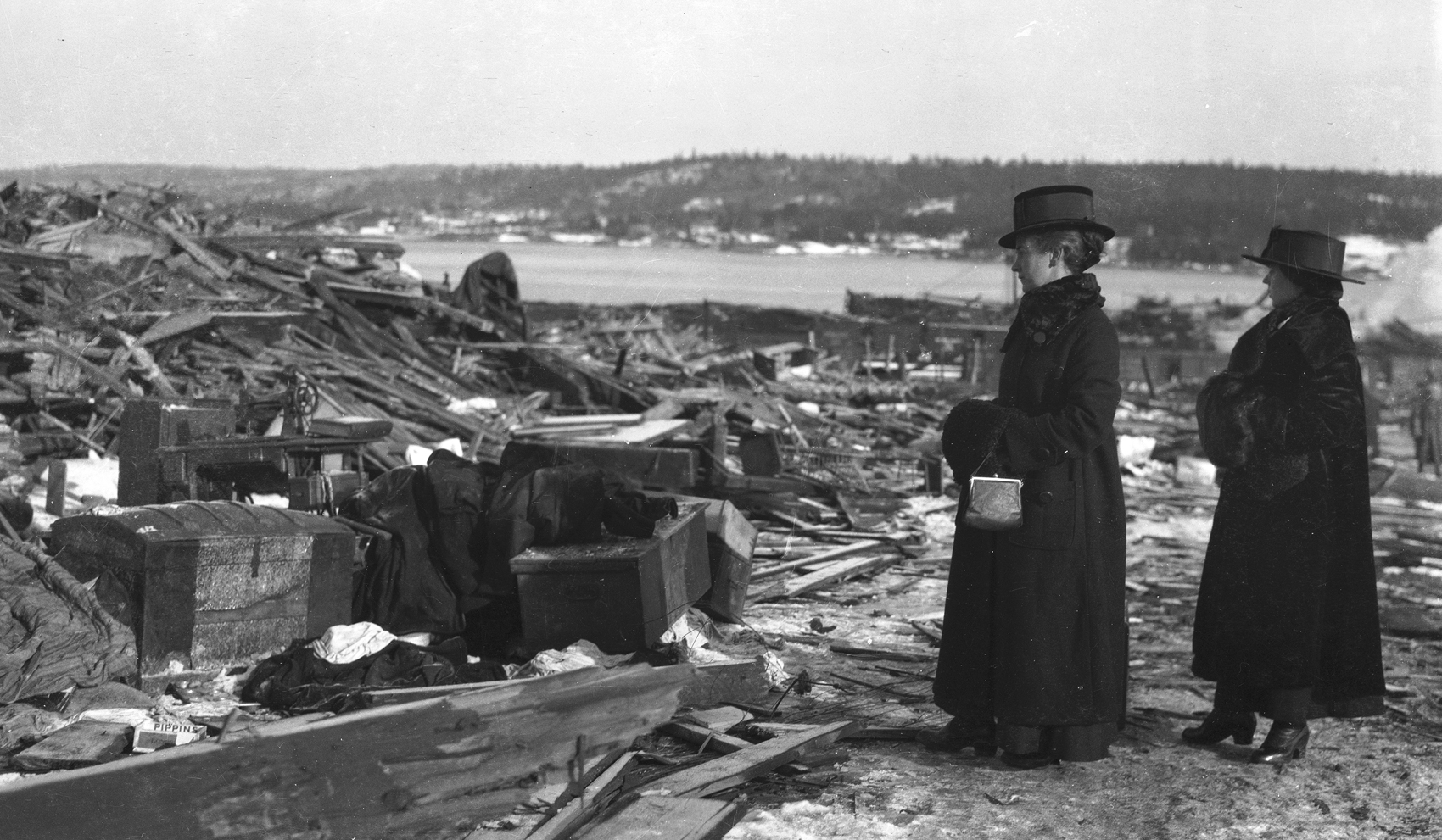 Women looking at debris after Halifax explosion. – December, 1917